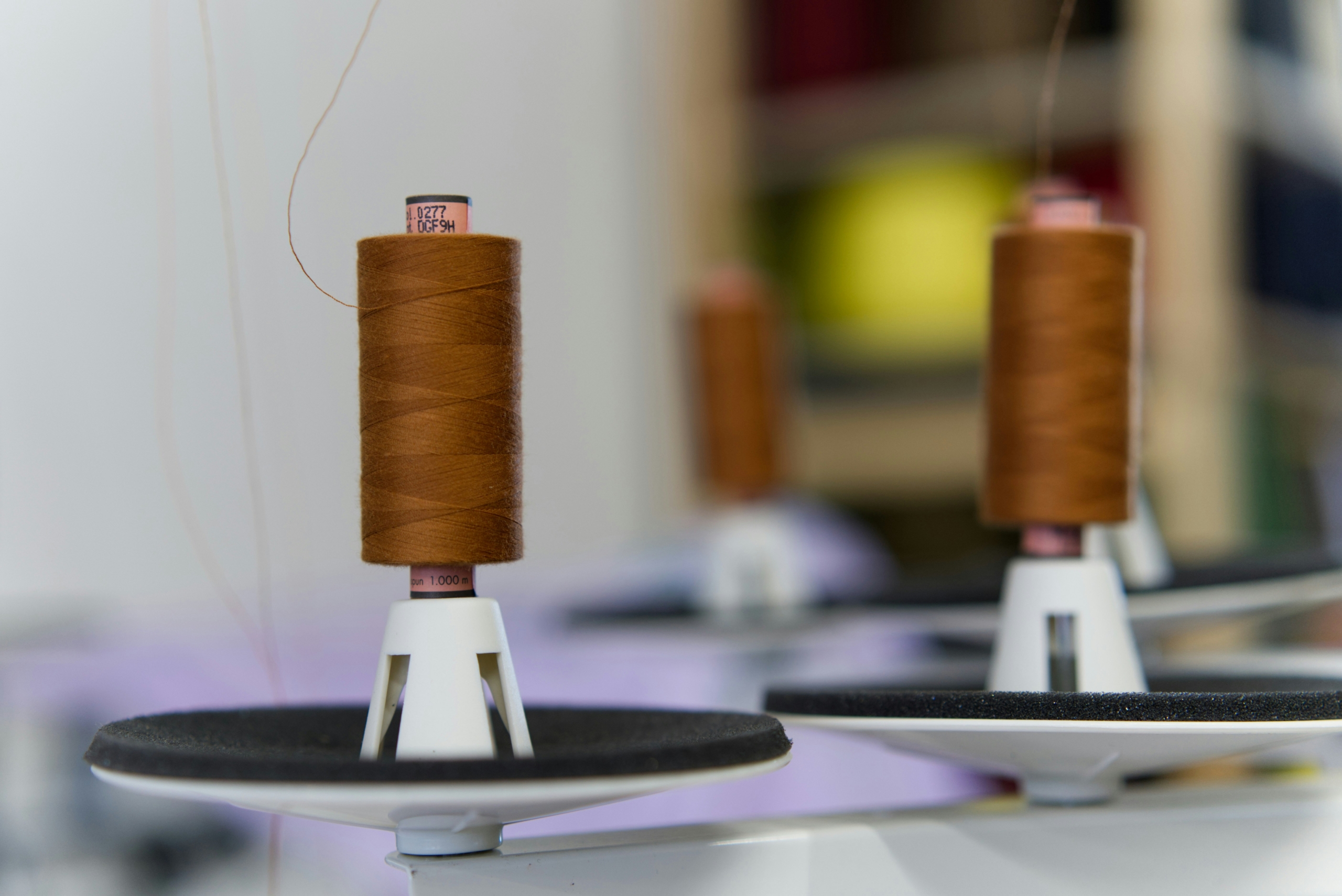 a spool of thread sitting on top of a white plate